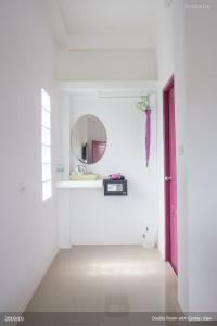 baño con espejo y puerta rosa en KeereeLay --- SHA Extra Plus ---, en Ko Lanta