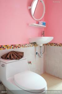Baño de color rosa con aseo y lavamanos en KeereeLay --- SHA Extra Plus ---, en Ko Lanta