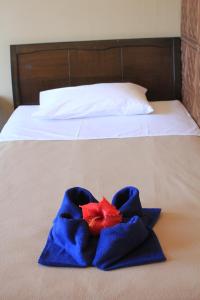a blue towel with a red star on a bed at City Lodge in Port Vila