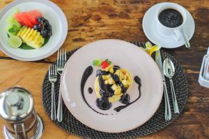 a plate of food with fruit on a table at La Numa Villas Canggu in Canggu