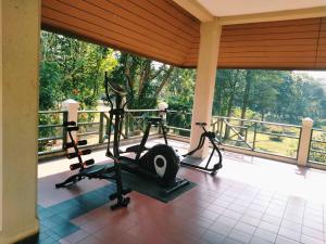 a gym with two tread machines in a room with a window at Aekpailin River Kwai Resort in Kanchanaburi