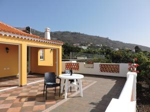 a patio with two chairs and a table on a roof at Casa Mar in Tijarafe