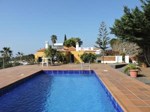 a swimming pool with a house in the background at Casa Mar in Tijarafe