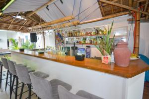 a bar with chairs and bottles on the wall at Boracay Backpackers in Boracay