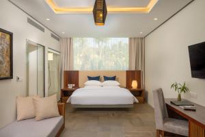 a bedroom with a white bed and a window at The Villa by Metta in Siem Reap