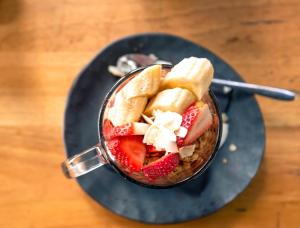 a banana split in a bowl on a table at Melbourne Metro YHA in Melbourne