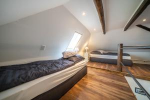 Postel nebo postele na pokoji v ubytování OSTLAND LOFT im INSEL-LAND-HOTEL MICHAELSEN