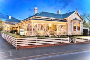 a house with a white fence in front of it at Kurrajong House in Launceston