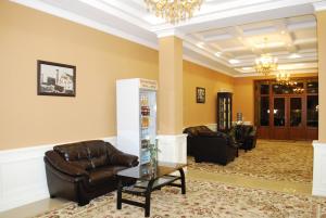 a living room with a couch and a table at Jahon Palace in Samarkand