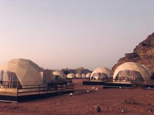 
a number of tents on top of a dirt field at Sharah Luxury Camp in Wadi Rum
