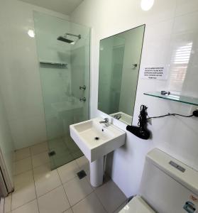 a bathroom with a sink and a shower and a toilet at Grand Hotel in Newcastle