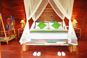 a bedroom with a bed with a canopy at Galang hari villa in Ubud