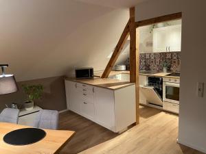 a kitchen with white cabinets and a table at Hunsrück-Juwel in Kastellaun