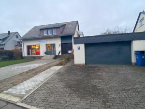 a house with a garage and a driveway at Hunsrück-Juwel in Kastellaun