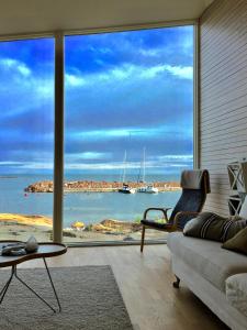 ein Wohnzimmer mit einem großen Fenster mit Meerblick in der Unterkunft Klipphus 3 Guerilla Hotel - Geta, Åland in Geta