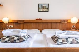 a bed with two pillows on top of it at Seelacherhof in Sankt Kanzian