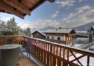 a balcony with a view of a snow covered mountain at Ski & Golf Apartments by Kaprun Rentals in Kaprun
