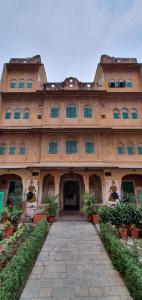 a large building with a walkway in front of it at Jaipur Haveli in Jaipur