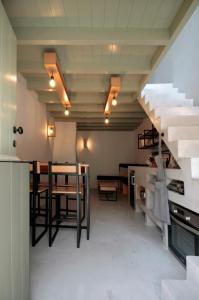 Zimmer mit einer Treppe, einem Tisch und Stühlen in der Unterkunft New Guesthouse in Emporios in Emporeiós