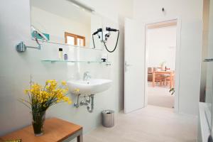 a bathroom with a sink and a mirror at Eol Apartments Viganj in Viganj