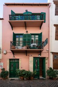 
a building with two windows and a balcony at Anastasia Apartments in Chania
