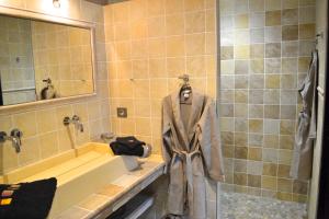 a bathroom with a robe hanging on a rack at les tamaris in Castelnau-sur-Gupie