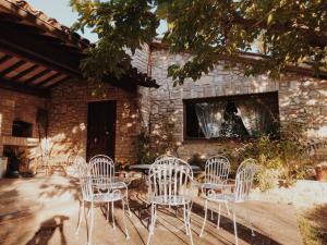a group of white chairs sitting in front of a building at La Pupazza Bed&Breakfast in Avigliano