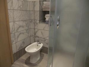 a bathroom with a toilet and a glass shower door at Apartments 2 Ivanković in Stari Grad +40 photos