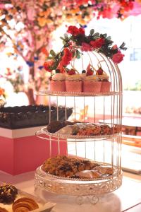 a display case filled with different types of cakes at One Patio Hotel Pattaya - SHA Extra Plus in Pattaya Central