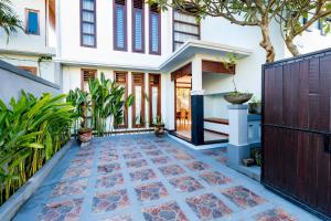 a home with a pathway leading to the front door at Villa Chandra - 3 Bedroom Villa with Private Pool in Seminyak