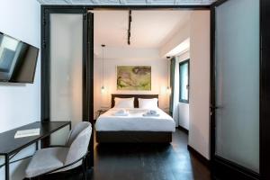 a bedroom with a bed and a desk and a tv at Sarri 2 by Stay Unique in Athens