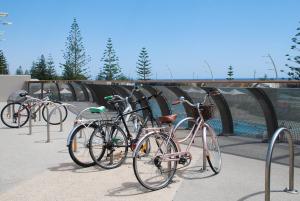 a group of bikes parked next to a bridge at Scarborough Apartment in Perth