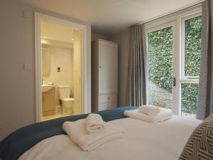 En eller flere senge i et værelse på 4 Keeper's Cottage, Hillfield Village