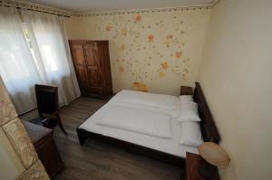 a small bedroom with a white bed and a window at Seehotel Europa in Schwanau +56 photos