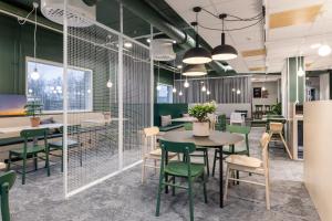una sala da pranzo con sedie verdi e tavolo di GreenStar Hotel Vaasa a Vaasa