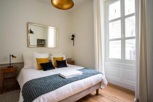 - une chambre avec un lit avec un miroir et une fenêtre dans l'établissement Pour une escapade à Nantes, face au Musée d’Arts, à Nantes