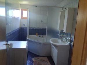 a bathroom with a tub and a sink and a bath tub at SARAJEVO-ADI APARTMENTS II in Sarajevo +9 photos