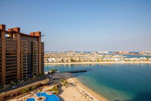 an aerial view of a beach and the ocean at Maison Privee - Spacious Apt on Palm Jumeirah w Sea Views and Premium Facilities Access in Dubai