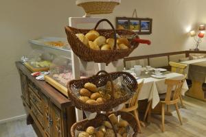 a table with baskets of bread on a counter at Gästehaus Wildbach in Mittelberg