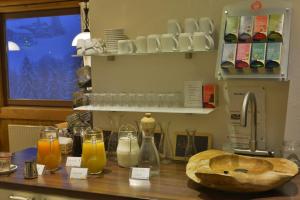 a kitchen with a counter with some drinks on it at Gästehaus Wildbach in Mittelberg