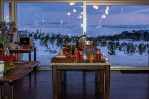 a table with drinks on it in front of a window at 360 Hotel & Thermal Baths in Selfoss