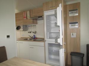 a kitchen with an empty refrigerator in a room at Mobilheim Adler Horst in Lachtal