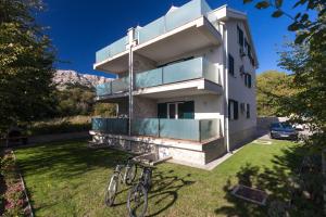 a house with two bikes parked in the yard at Relax 3 in Baška