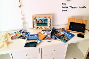 a table with books and a tablet on it at Casadamarepg Gallipoli in Pizzo