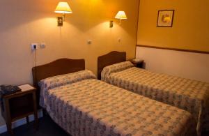 Postel nebo postele na pokoji v ubytování Hôtel de Flandre