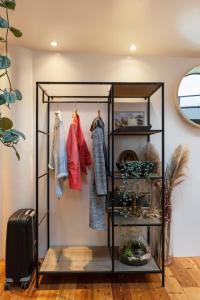 a walk in closet with a shelf and clothes at B&B Houseboat Amsterdam in Amsterdam