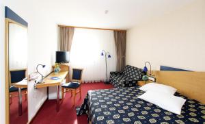 
a hotel room with two beds and a desk at Iris Hotel in Oradea
