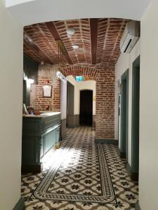 a hallway with a tile floor and a brick wall at Royal Tophane in Istanbul