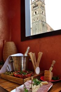 a table topped with a bowl of food next to a window at B&B Casa Faccioli in Bologna