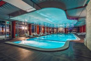 a large swimming pool in a hotel room at Carine Hotel Delfin in Bijela